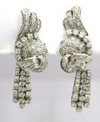 A pair of intricate diamond earrings having removable drops, one diamond deficient,