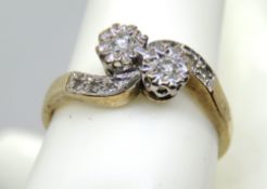 A 9ct gold and diamond ring having two illusion set stones in twist style setting set with three