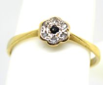 A delightful early 20th century 18ct gold and platinum ring having floral design set with sapphire