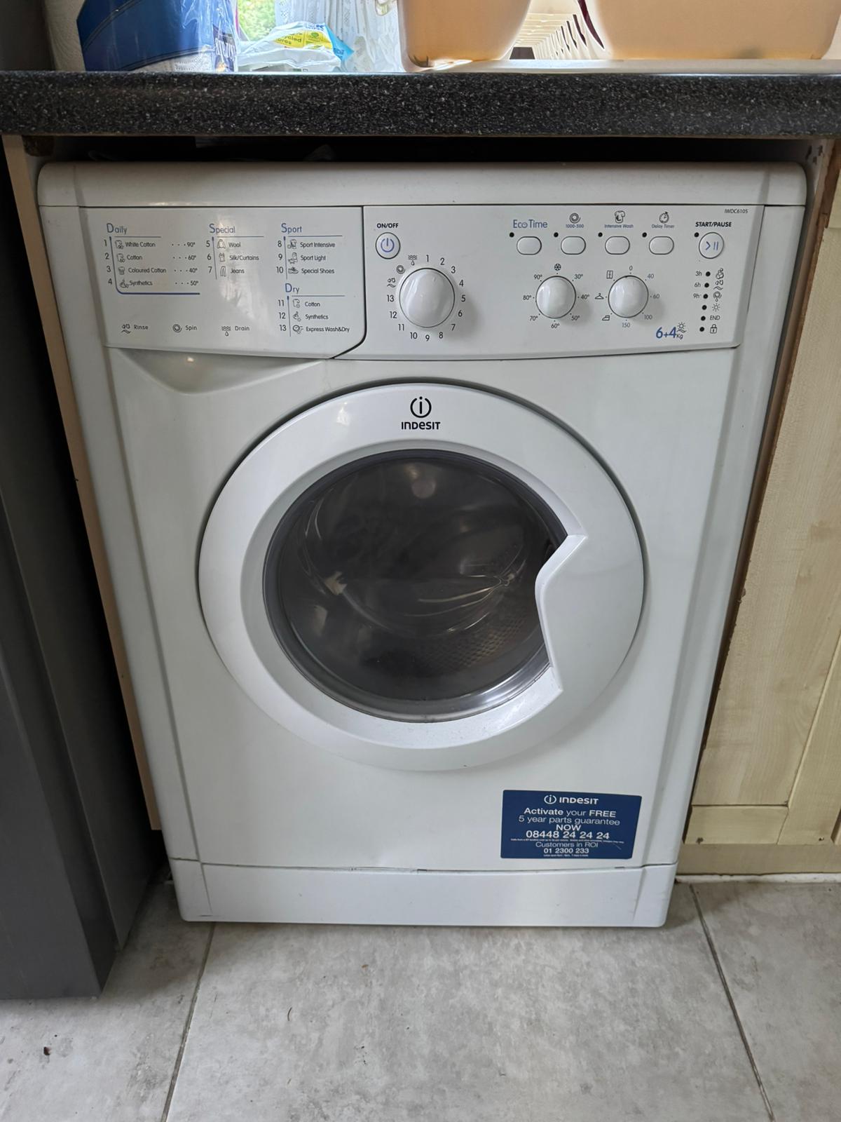 An Indesit IWDC6105 6+4kg washing machine.
