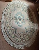 A 20th century woollen oriental rug, pink ground with floral decoration, 214 x 140cm.