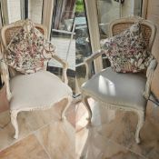 A pair of cane back bergère work Continental style salon chairs, painted.