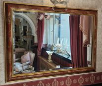 A contemporary bevel edged square shaped wall mirror with decorative floral frame, 102 x 72cm.