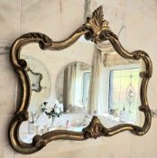 A contemporary Continental style gilded and shaped wall mirror, 83 x 70cm.