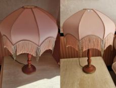 A pair of matching turned side table lamps, each with Art Deco style fringed shades, 65cm high.