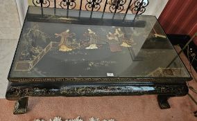 An Oriental low square shaped centre table having applied figural decoration and raised on squat