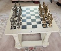 A contemporary chess centre table with full complement of metal chess pieces, 60 x 60 x 44cm.