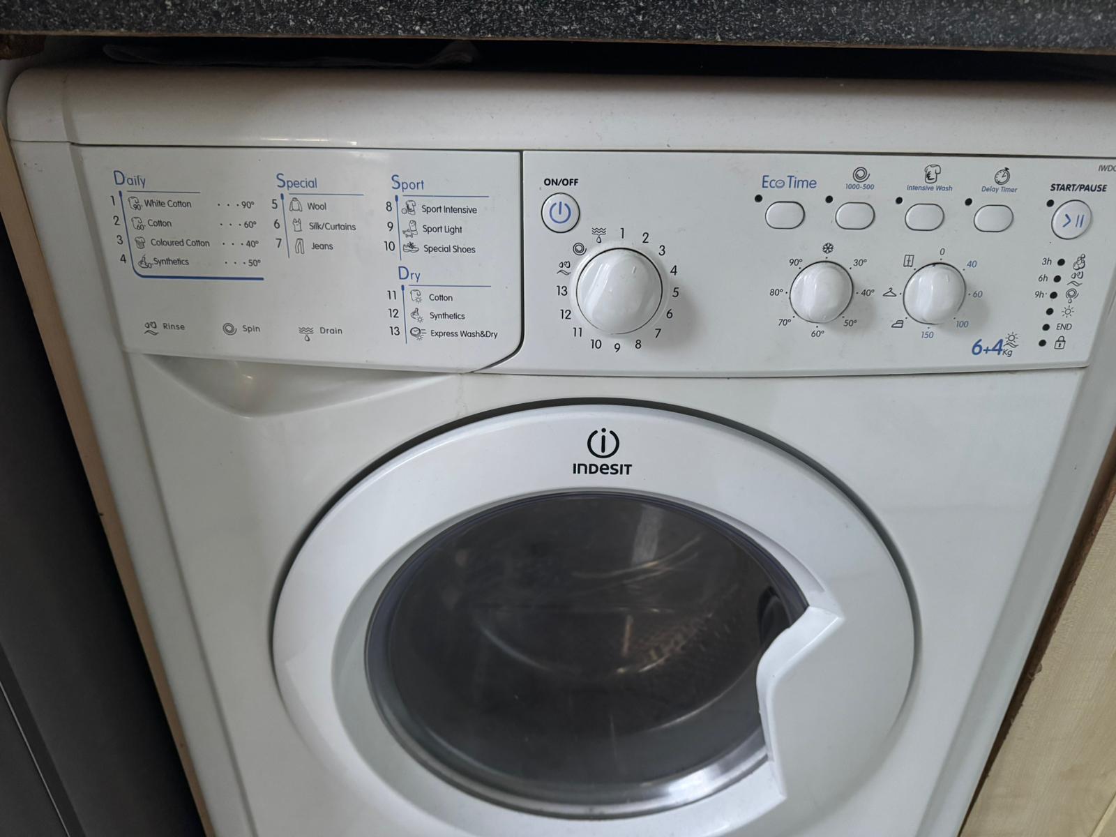 An Indesit IWDC6105 6+4kg washing machine.
