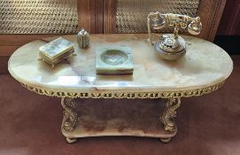 An oval onyx occasional table c1970s with dolphin type supports, solid undershelf,