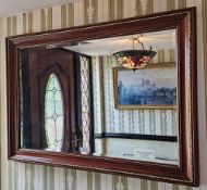 A contemporary mahogany framed wall mirror, 102 x 73cm.