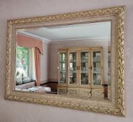 A contemporary decorative part gilded, bevelled edge wall mirror, 110 x 80cm.
