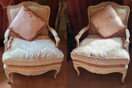 A fine pair of 20th century Continental style salon chairs with loose cushions.