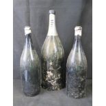 Three large empty Champagne bottles including PIper standing approx 23" high.