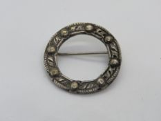 A silver Celtic style wreath brooch hall