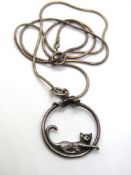 A silver cat and mouse pendant on silver chain.