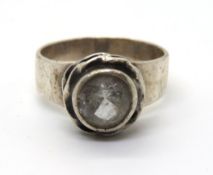 A white stone ring, no apparent hallmarks, size N-O.