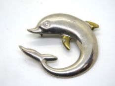 A silver dolphin brooch stamped Laton Mexico 925.