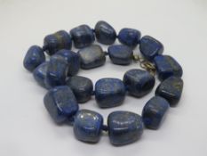 A large lapis lazuli bead necklace.