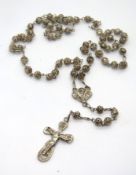 A filigree crucifix on chain, no apparent hallmarks.