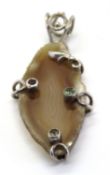 A large hardstone pendant set in silver,
