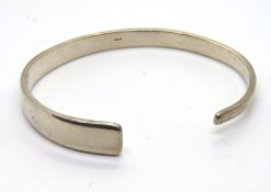 A hallmarked silver bangle of graduated form, 22.1g.
