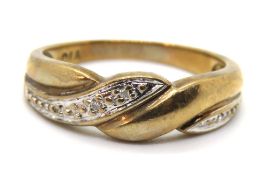 A 9ct gold ring having twist design with diamonds set in white metal, hallmarked 375, size K, 2.1g.