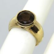A substantial 9ct gold ring with rubover set round cut solitaire citrine, hallmarked 375, size L, 3.