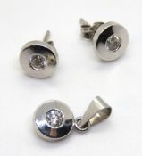 A suite of white metal jewellery comprising pendant and pair of earrings,