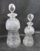 A graduated pair of waisted decanters having etched Scottish thistle design upon.