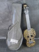 A Mahalo Creative Skull Soprano Ukulele in a cracked black and gold finish, with original bag.