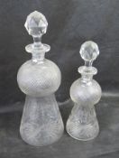 A graduated pair of waisted decanters having etched Scottish thistle design upon.