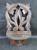 A black forest type carved wooden shelf.