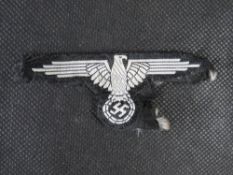 A reproduction WWII German Waffen SS cloth tunic Eagle.