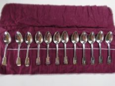 A set of twelve HM silver spoons in roll having matching engraved crests upon,