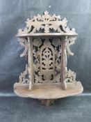 A black forest type carved wooden shelf.