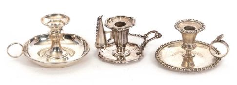 A group of three small silver chamber sticks to include a George IV example with gadrooned rims
