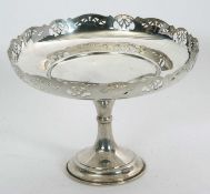 A George V silver pedestal dish having a raised pierced edge, plain ground shallow bowl, single