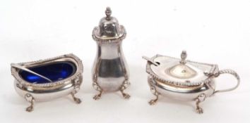 An Elizabeth II silver three piece condiment set comprising pepper, mustard and open salt, each on
