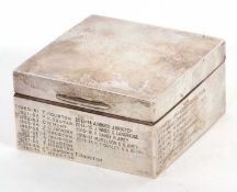 A hallmarked silver table cigarette box of square form, presentation engraved for the Norfolk &