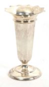 A large George V silver vase of plain cylindrical tapering form having a wavy rim and a loaded base,