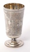 A late Victorian silver goblet of tapering cylindrical form, chased and engraved with birds, flowers
