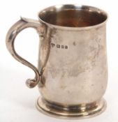 A George V silver plain tankard of baluster form, hallmarked for London 1928, makers mark for