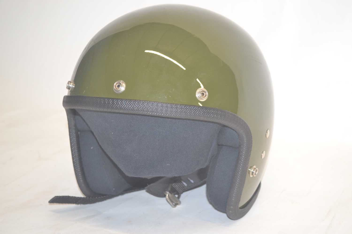 Open faced fibreglass military motorcycle helmet.