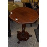 A Victorian mahogany wine table with octagonal top and paw feet