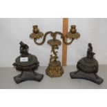 A gilt metal two branch candlestick and a pair of metal table centrepieces