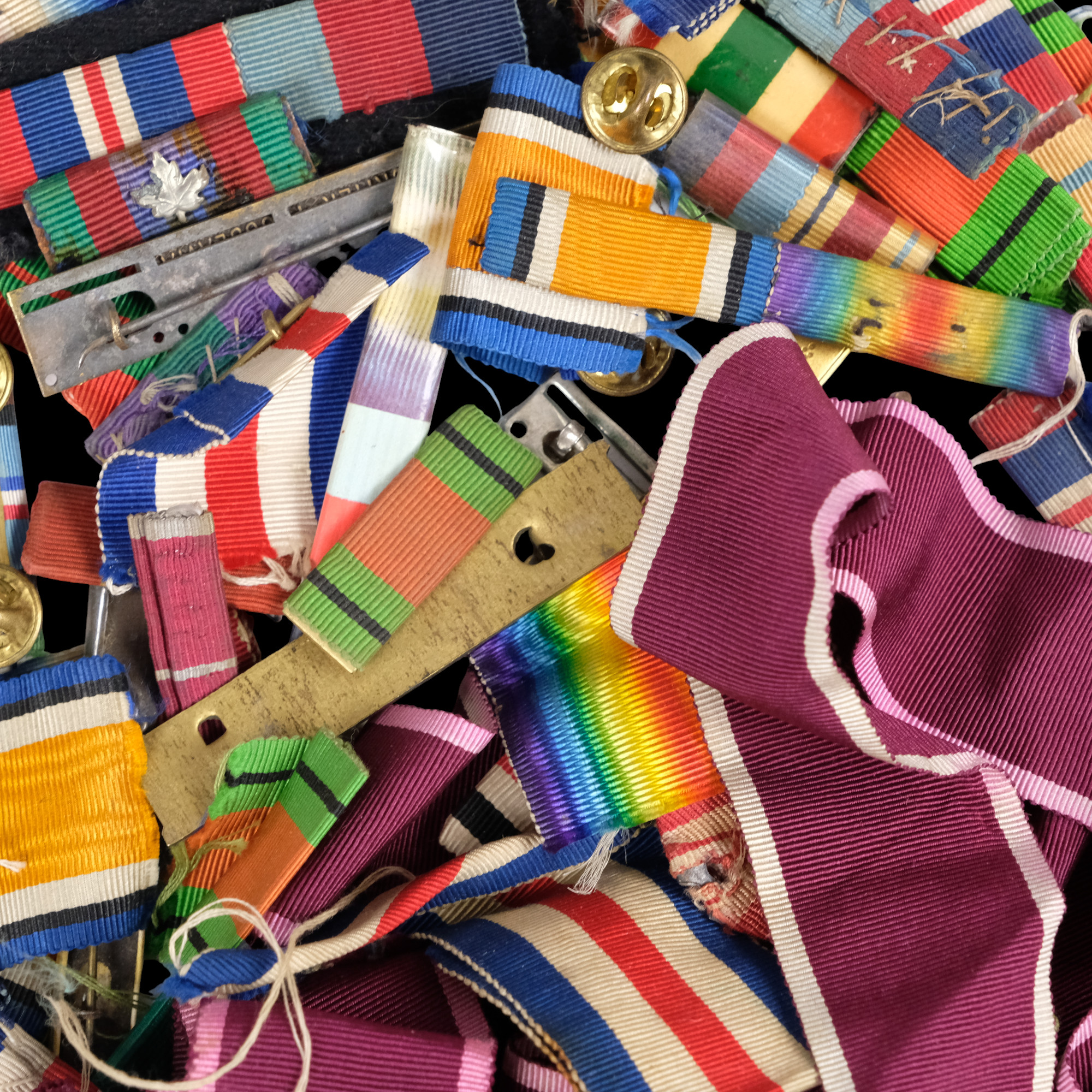A group of largely British medal ribbons and mounting bars, etc