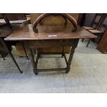 A 19th century oak table with single drawer on turned supports