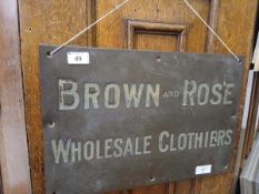 A brass plaque for 'Brown and Rose Wholesale Clothiers', 31 x 46 cm
