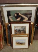 A collection of framed pictures and prints