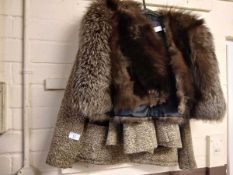 A tweed skirt and jacket with a fox fur opera cape